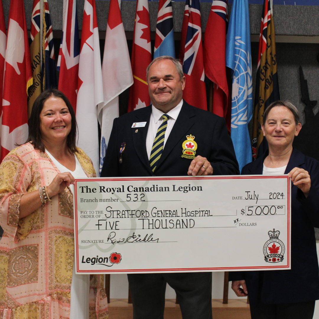 large group of people holding a large cheque